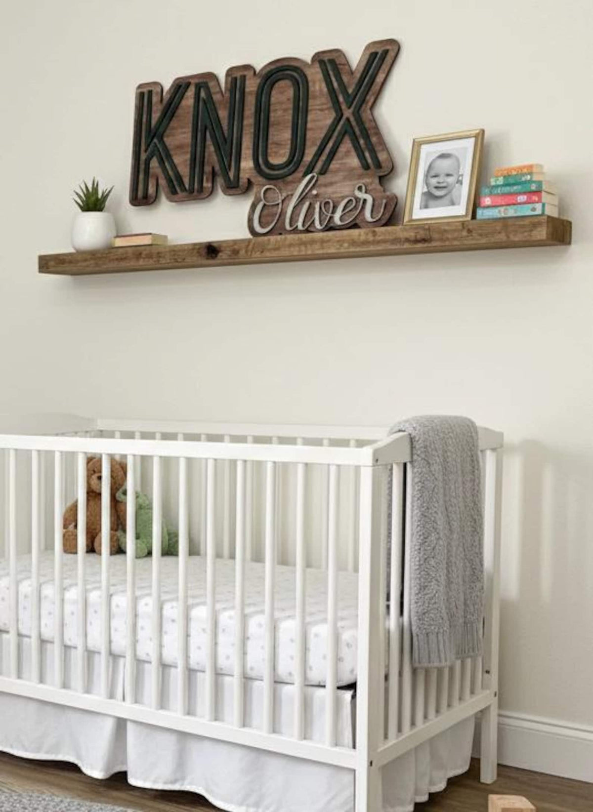 KNOX Oliver name sign on a shelf above a crib