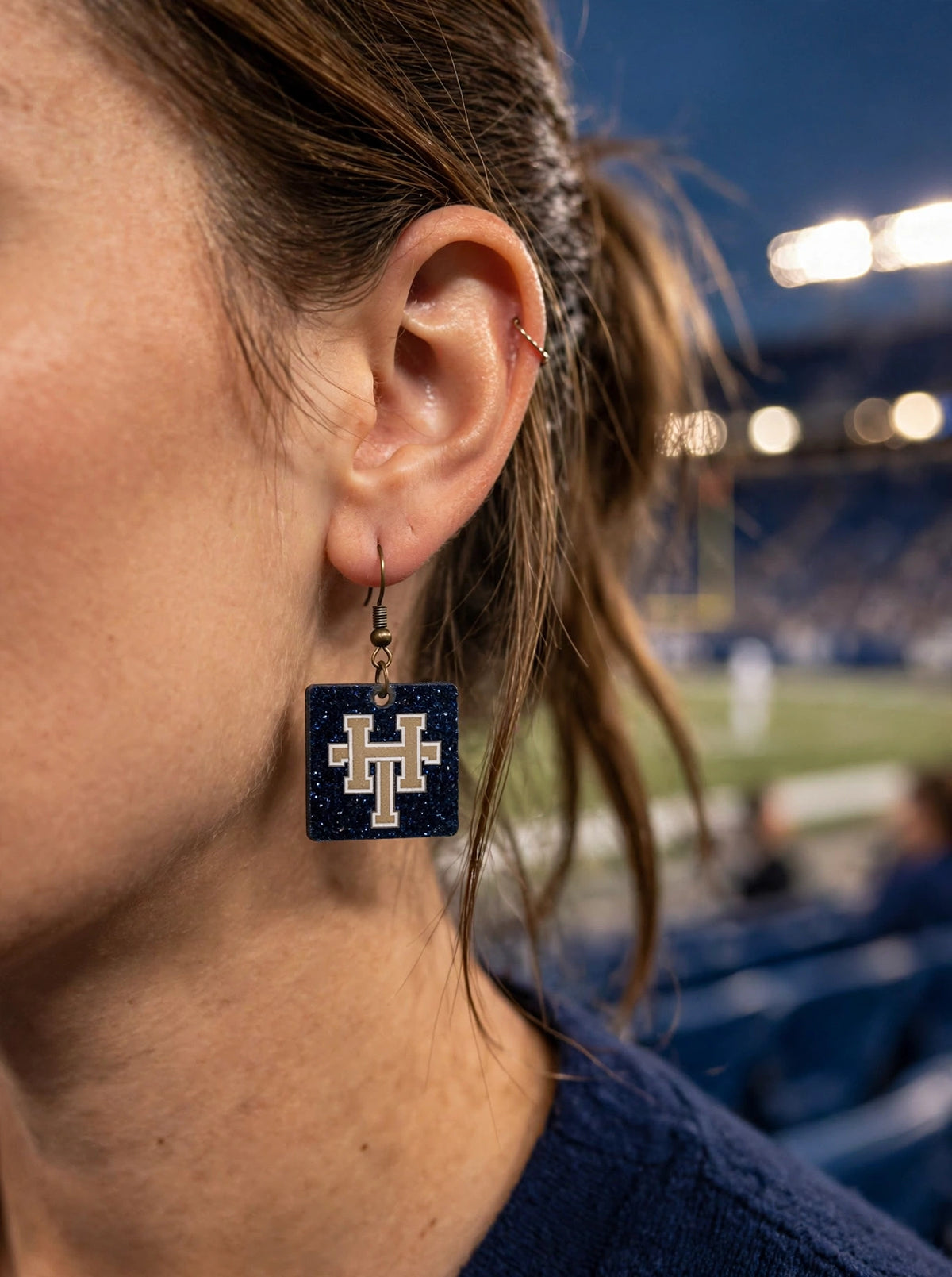 HT Square earrings worn at the stadium
